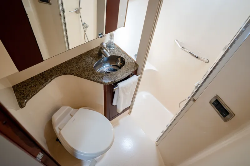 Slide: The Image of Luxurious bathroom in 2006 Sea Ray 44 Sedan Bridge yacht with granite countertop and shower. - 33
