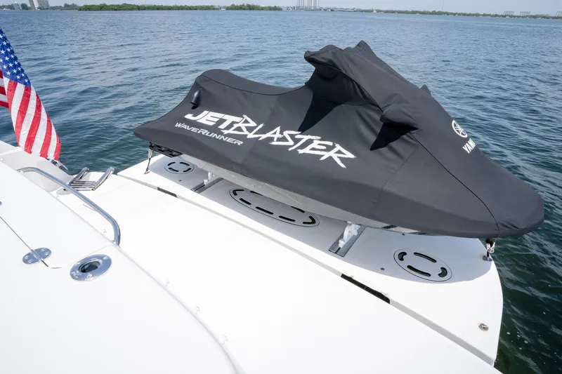 Slide: The Image of Jet ski on 2006 Sea Ray 44 Sedan Bridge yacht, covered and docked on calm water. - 9