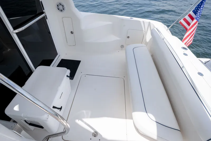 Slide: The Image of 2006 Sea Ray 44 Sedan Bridge boat deck with seating and American flag. - 11