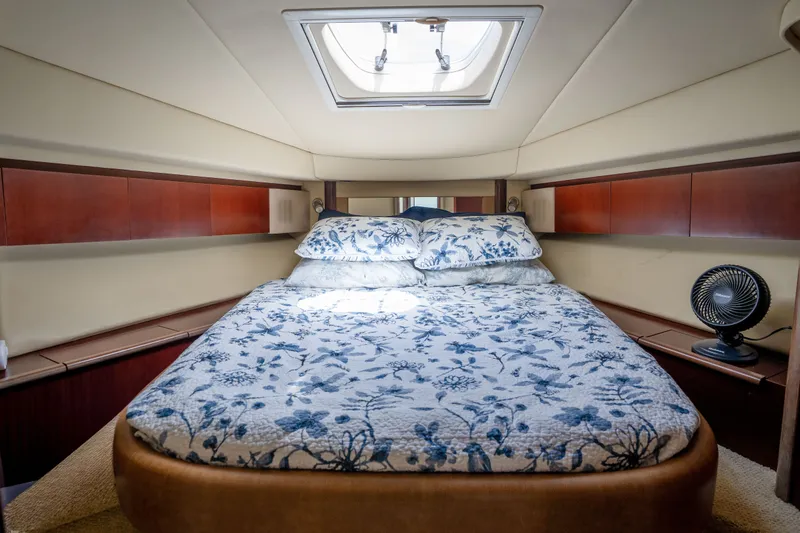 Slide: The Image of Luxurious 2006 Sea Ray 44 Sedan Bridge cabin with floral bedding and elegant wood accents. - 32