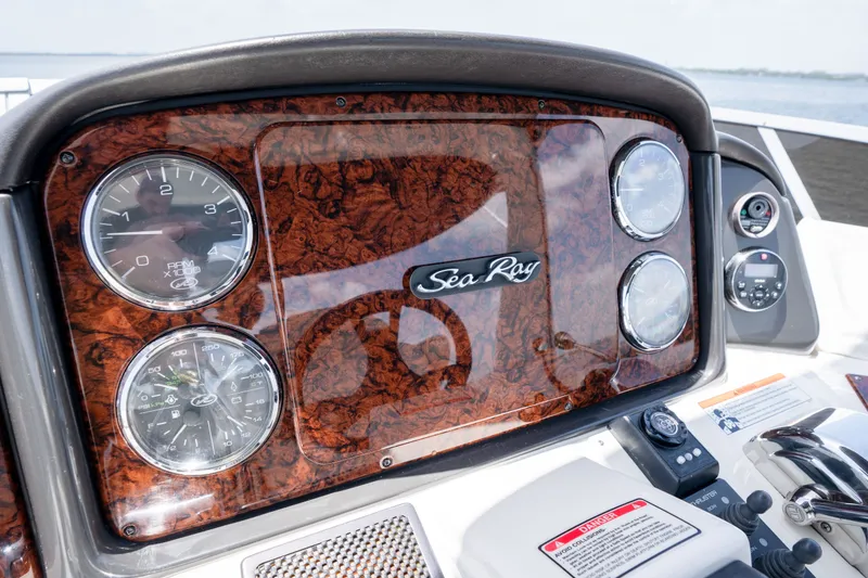Slide: The Image of Dashboard of a 2006 Sea Ray 44 Sedan Bridge boat with wood finish and gauges. - 19