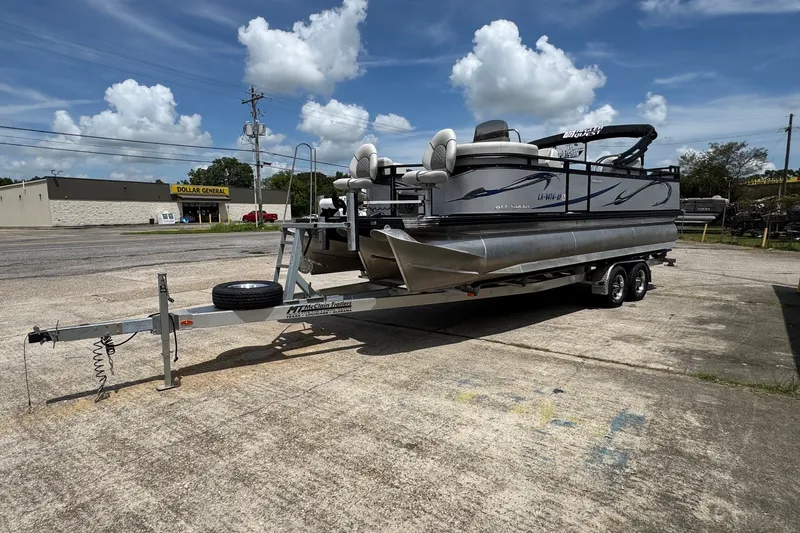 The Image of 2023 Angler Qwest 8522 All Sport Gen II Triple Tube pontoon on trailer, parked outdoors. - 1