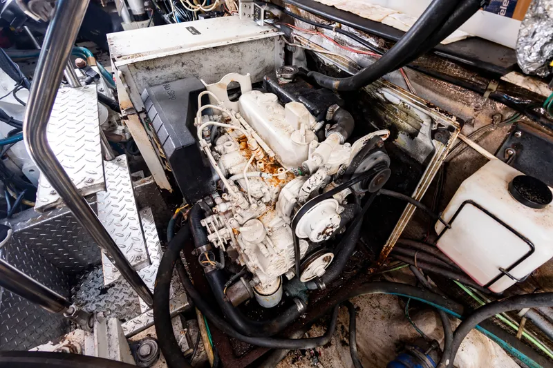 Slide: The Image of Engine room of a 2004 Albemarle 410 Express Fisherman with visible engine and wiring. - 49