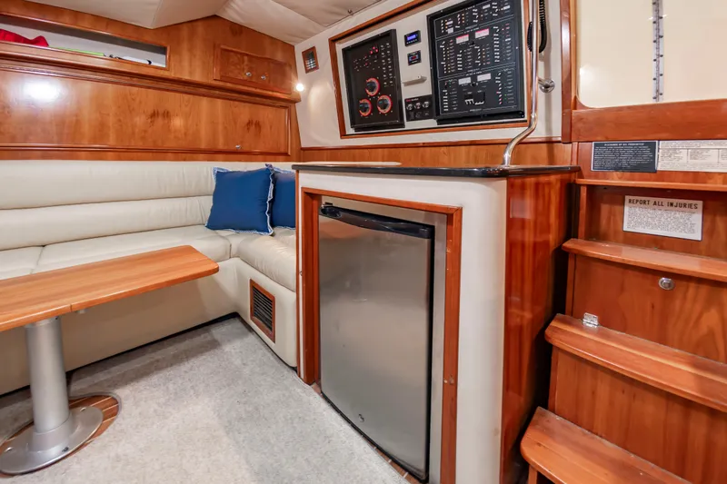 Slide: The Image of Interior of the 2004 Albemarle 410 Express Fisherman with seating area, fridge, and control panel. - 35