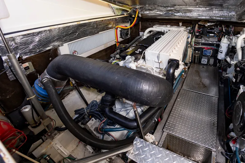 Slide: The Image of The engine room of a 2004 Albemarle 410 Express Fisherman with a large engine and technical components. - 47