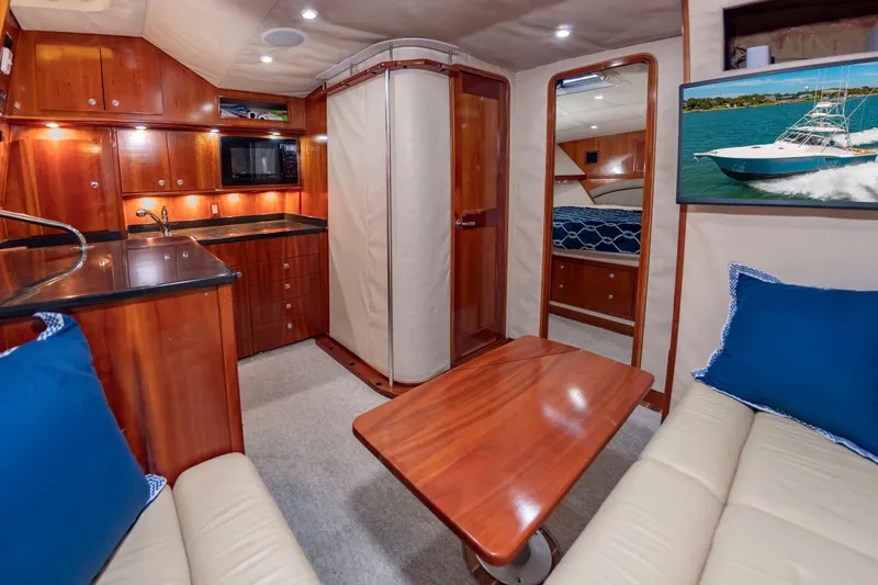 Slide: The Image of Interior of the 2004 Albemarle 410 Express Fisherman with wood furnishings and blue cushions. - 32