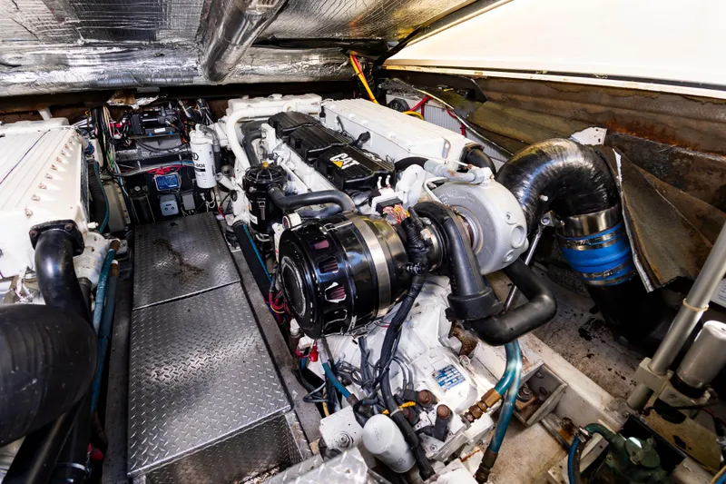 Slide: The Image of The engine room of a 2004 Albemarle 410 Express Fisherman with a large engine and various components. - 46