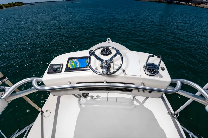 Slide: The Image of The image shows the helm of a 2004 Albemarle 410 Express Fisherman with a modern navigation system. - 26
