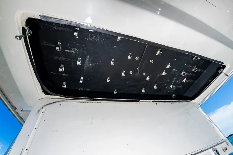 Slide: The Image of Open hatch of a 2004 Albemarle 410 Express Fisherman, revealing storage space beneath. - 24