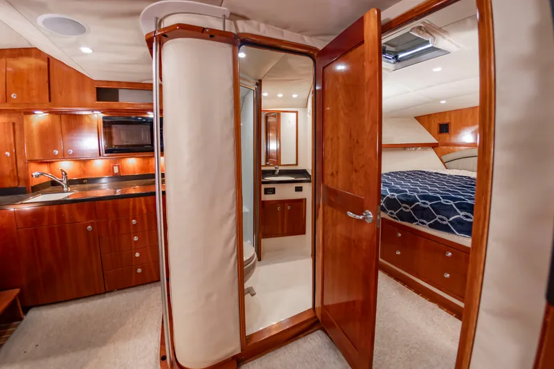 Slide: The Image of Interior of a 2004 Albemarle 410 Express Fisherman with wood cabinetry and a cozy bedroom. - 39