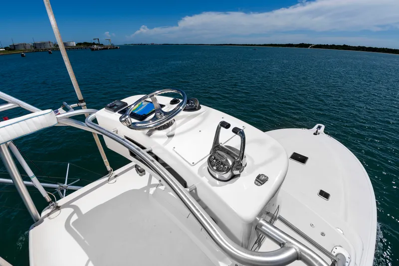 Slide: The Image of The image shows the helm of a 2004 Albemarle 410 Express Fisherman. It is set on a boat overlooking open water and blue sky. - 27