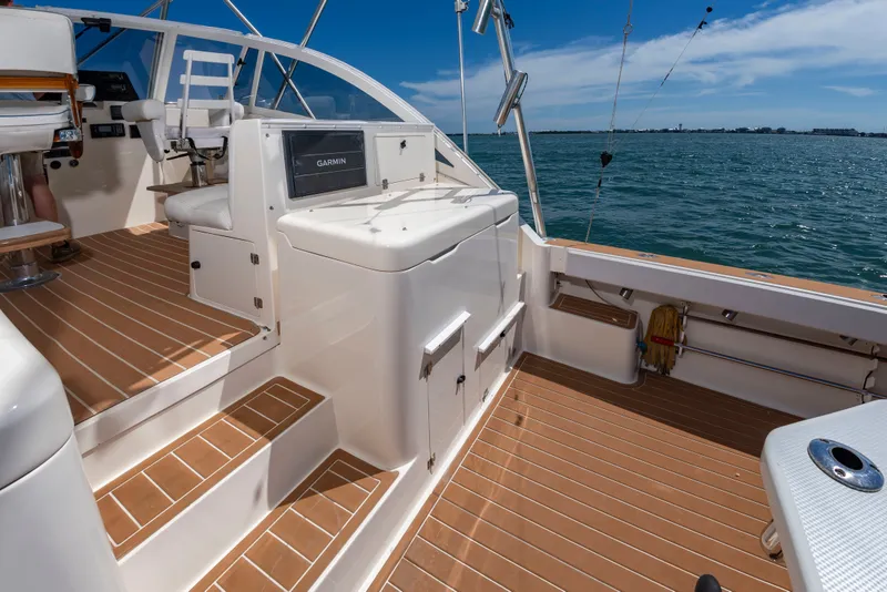 Slide: The Image of The image shows the cockpit of a 2004 Albemarle 410 Express Fisherman. It features wood flooring and a Garmin display. - 15
