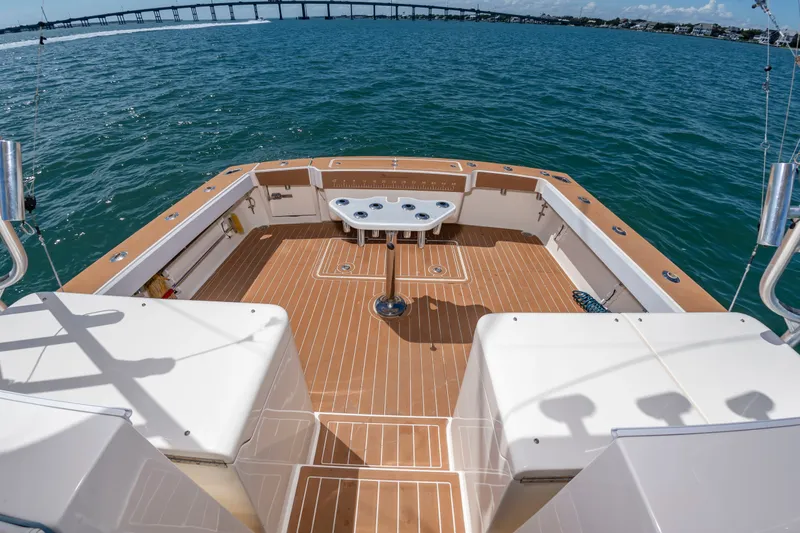 Slide: The Image of The image shows the spacious aft deck of a 2004 Albemarle 410 Express Fisherman on the water. - 13