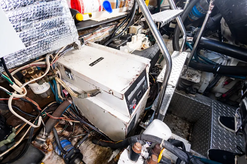 Slide: The Image of The engine room of a 2004 Albemarle 410 Express Fisherman with various equipment and cables. - 48