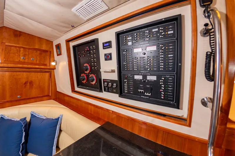 Slide: The Image of Electrical control panel in a luxurious boat cabin with wood paneling and blue cushions. - 36