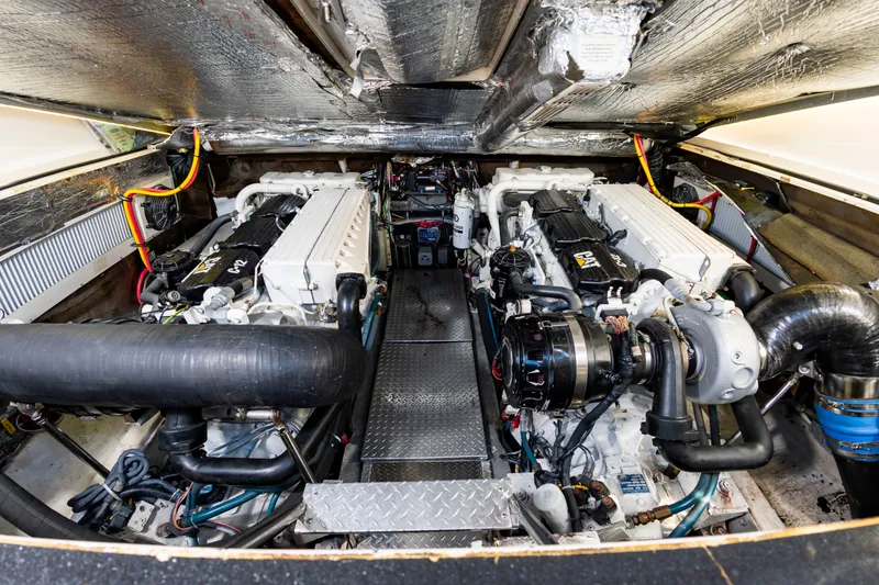 Slide: The Image of The engine room of a 2004 Albemarle 410 Express Fisherman with two large engines and insulation. - 45