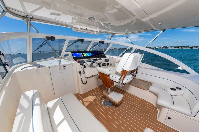 Slide: The Image of The image shows the cockpit of a 2004 Albemarle 410 Express Fisherman with a modern helm. - 20
