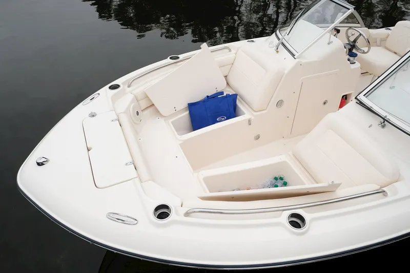 Slide: The Image of Manufacturer Provided Image: 2022 Grady-White Freedom 215 boat with open storage compartments on calm water. - 22