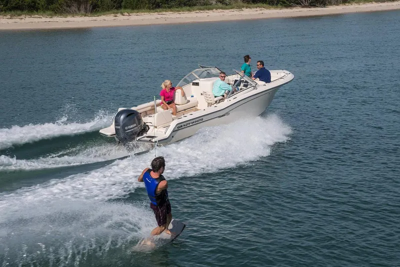 Slide: The Image of Manufacturer Provided Image: 2022 Grady-White Freedom 215 boat towing a wakeboarder on a sunny day. - 18