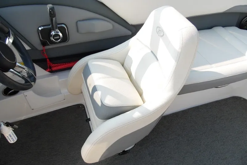 Slide: The Image of Interior of 2020 Cobalt 220S boat featuring white seating and steering controls. - 14