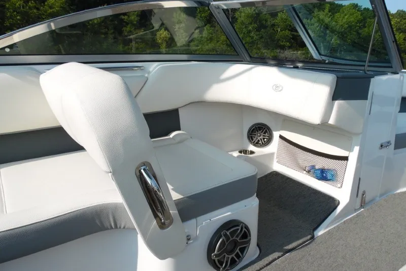 Slide: The Image of 2020 Cobalt 220S boat interior with white seating and speaker system. - 19