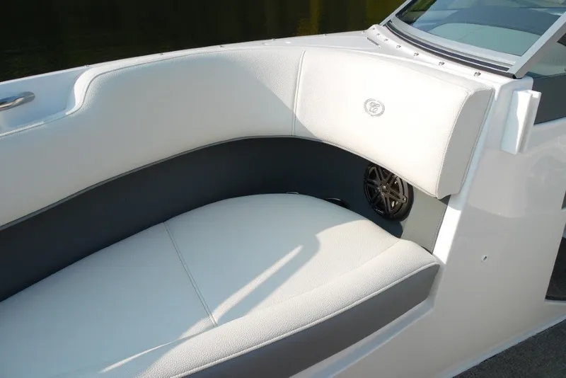 Slide: The Image of 2020 Cobalt 220S boat interior with white cushioned seating and speaker detail. - 24