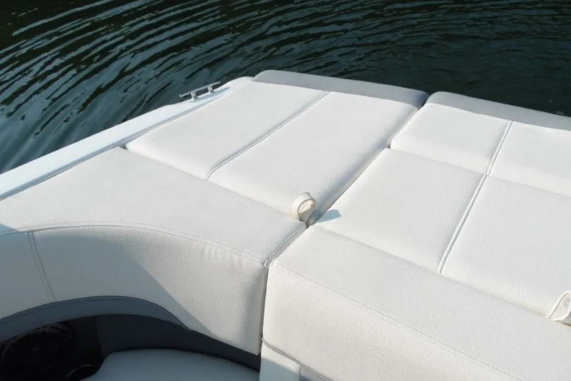 Slide: The Image of Cobalt 220S 2020 boat with white cushioned seating by the water. - 10
