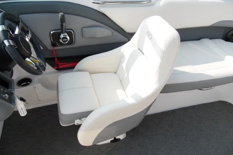 Slide: The Image of Interior of a 2020 Cobalt 220S boat featuring a white captain's chair and steering wheel. - 15