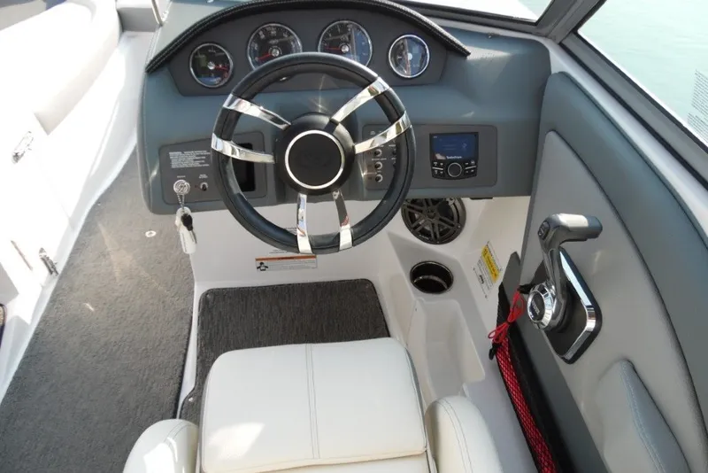 Slide: The Image of 2020 Cobalt 220S boat dashboard with steering wheel, gauges, and control panel. - 16