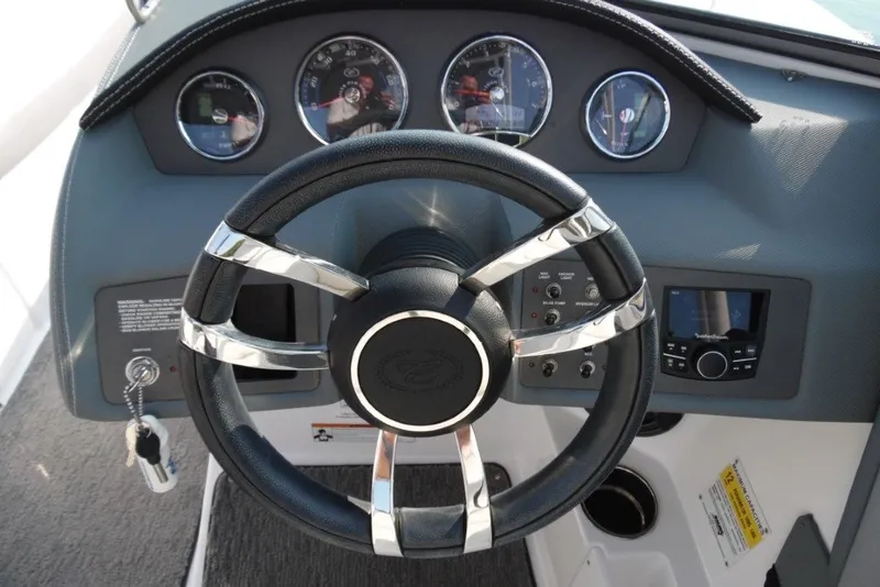 Slide: The Image of Steering wheel and dashboard of 2020 Cobalt 220S boat with gauges and controls. - 17