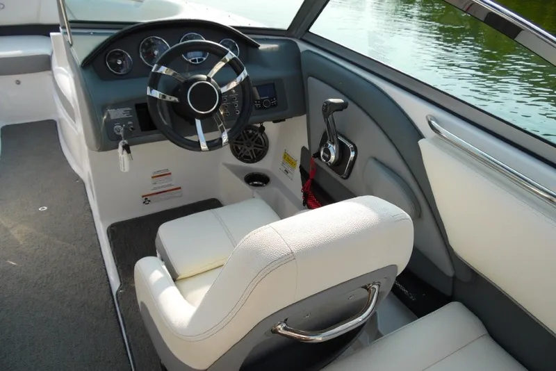 Slide: The Image of Interior of 2020 Cobalt 220S boat with steering wheel and control panel. - 13