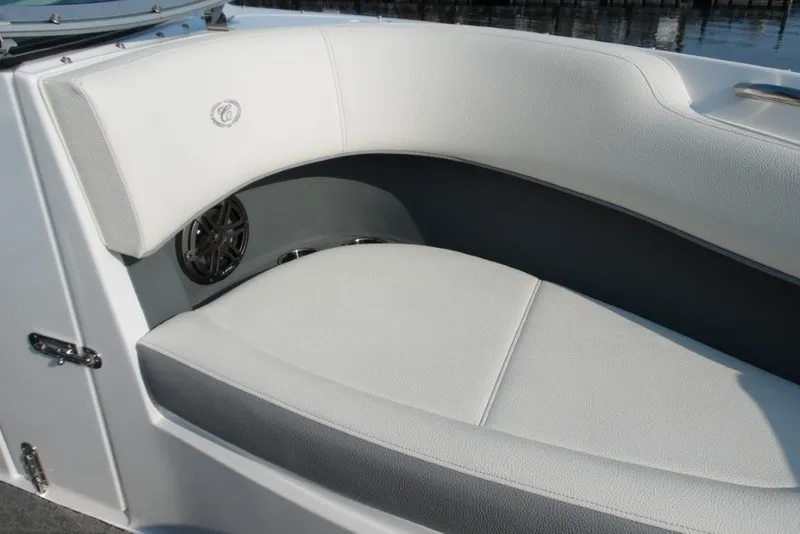 Slide: The Image of 2020 Cobalt 220S boat interior with white cushioned seating and speaker detail. - 23