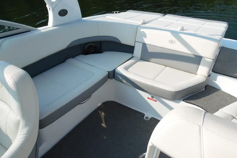Slide: The Image of 2020 Cobalt 220S boat interior with white and gray seating, on calm water. - 9