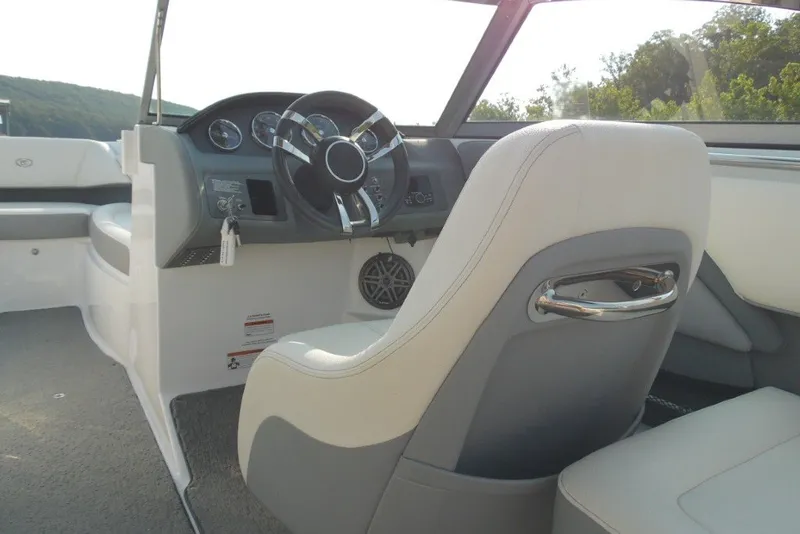 Slide: The Image of Interior view of a 2020 Cobalt 220S boat, featuring a sleek steering wheel and comfortable seating. - 12