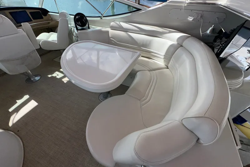 Slide: The Image of Luxurious interior of 2003 Carver 466 Motor Yacht with plush seating and table. - 54