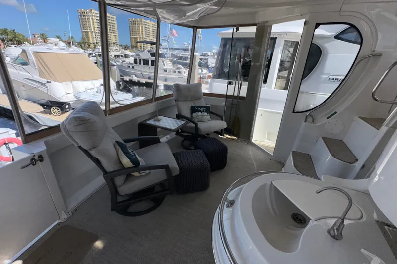 Slide: The Image of Luxurious 2003 Carver 466 Motor Yacht interior with plush seating and marina view. - 68