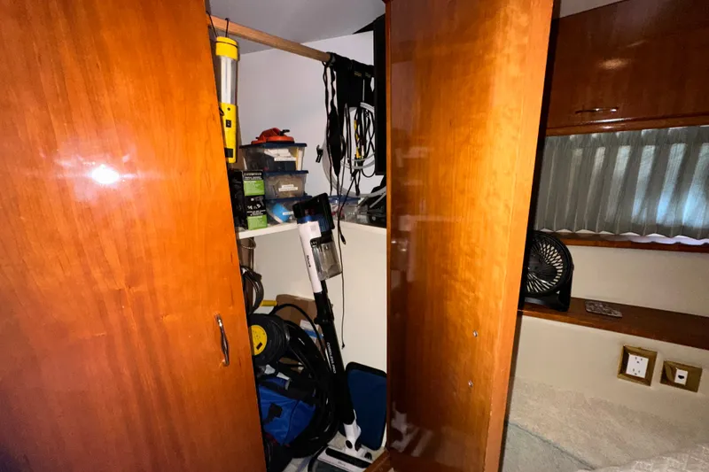 Slide: The Image of Storage area inside a 2003 Carver 466 Motor Yacht with wooden cabinets and various equipment. - 14
