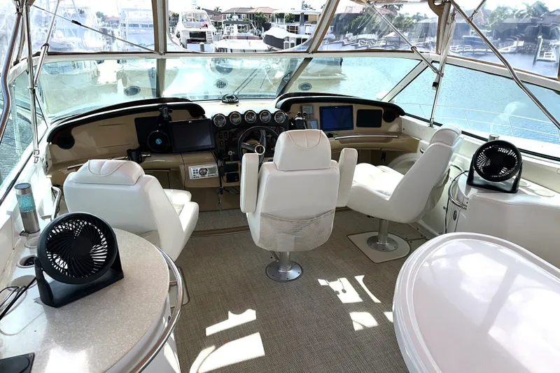 Slide: The Image of Interior of 2003 Carver 466 Motor Yacht cockpit with white seating and navigation equipment. - 51