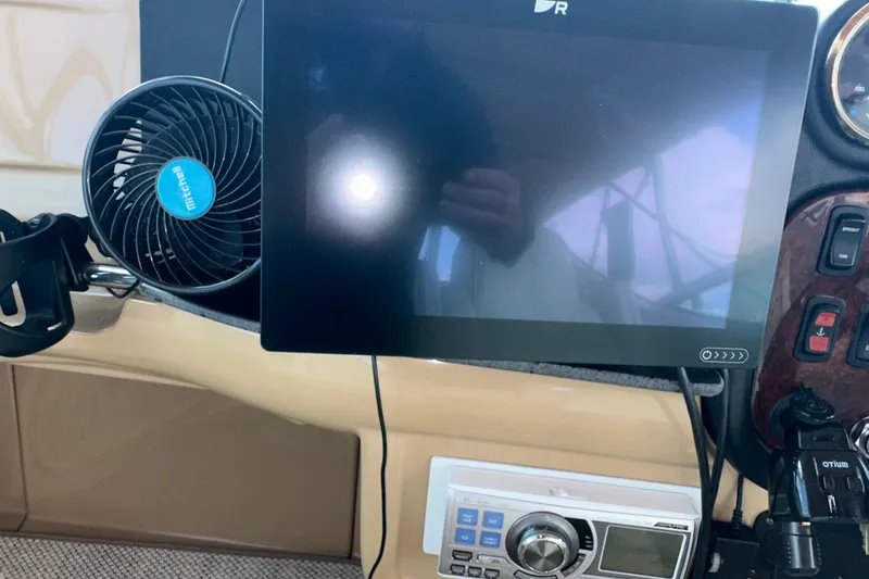 Slide: The Image of Control panel of a 2003 Carver 466 Motor Yacht with fan and display screen. - 58