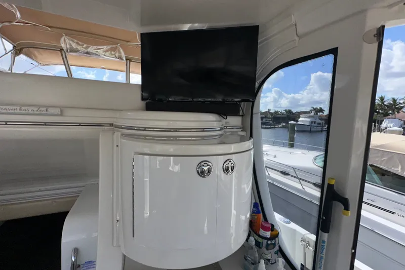 Slide: The Image of 2003 Carver 466 Motor Yacht interior with TV and marina view. - 71