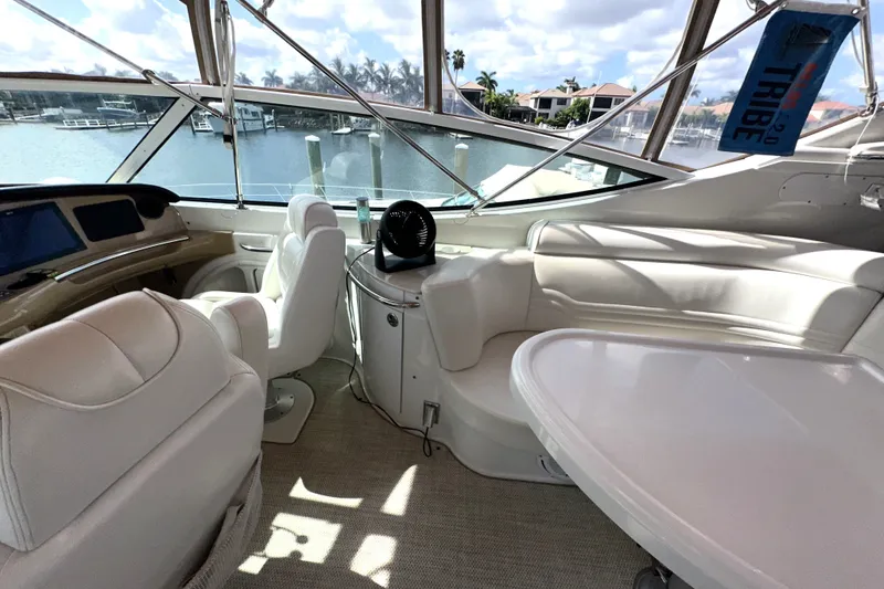 Slide: The Image of Luxurious interior of 2003 Carver 466 Motor Yacht with white seating and waterfront view. - 55