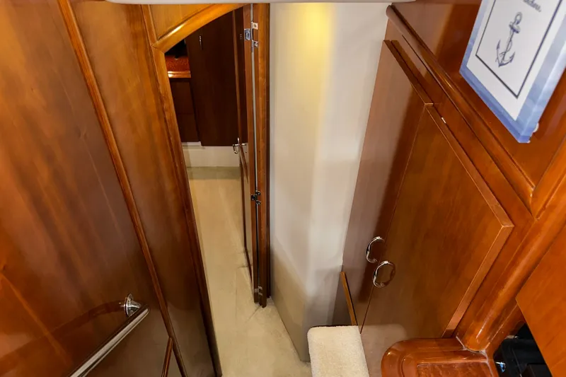Slide: The Image of Interior hallway of 2003 Carver 466 Motor Yacht with wooden cabinetry and carpeted floor. - 40