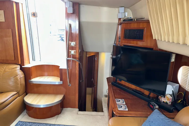 Slide: The Image of Interior of 2003 Carver 466 Motor Yacht with TV, stairs, and leather seating. - 37