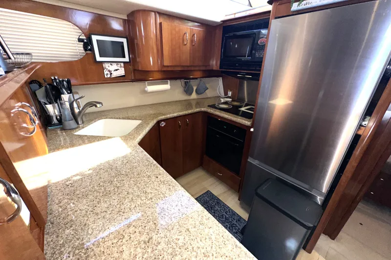 Slide: The Image of Luxurious kitchen in 2003 Carver 466 Motor Yacht with modern appliances and granite countertops. - 20
