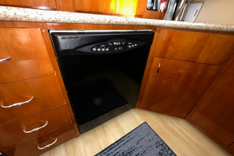 Slide: The Image of Kitchen area of 2003 Carver 466 Motor Yacht with dishwasher and wooden cabinetry. - 22