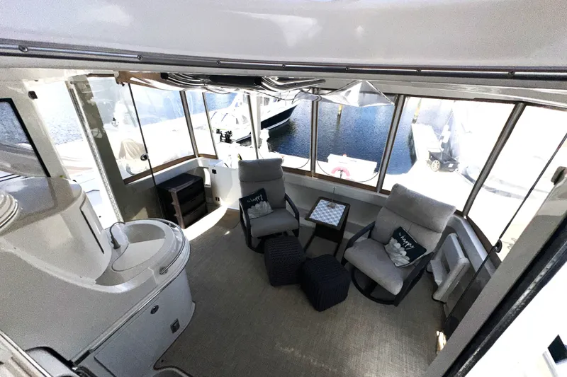 Slide: The Image of Luxurious interior of 2003 Carver 466 Motor Yacht with comfortable seating and panoramic windows. - 67