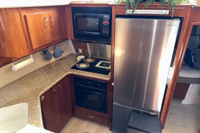 Slide: The Image of Kitchen area of a 2003 Carver 466 Motor Yacht with modern appliances. - 26