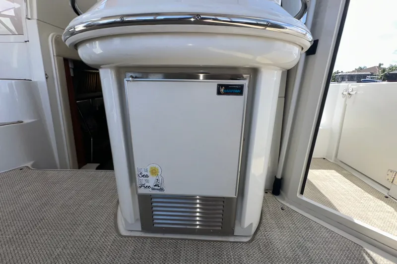 Slide: The Image of 2003 Carver 466 Motor Yacht interior with compact refrigerator and nautical decor. - 70