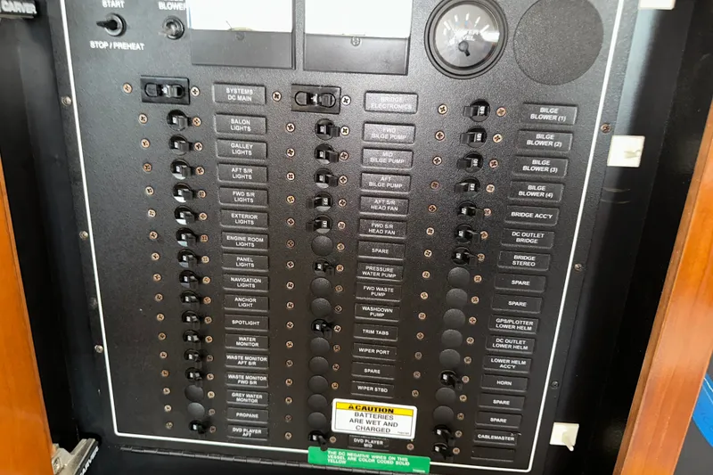 Slide: The Image of Electrical panel of a 2003 Carver 466 Motor Yacht with labeled switches and gauges. - 38