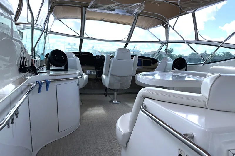 Slide: The Image of Interior of 2003 Carver 466 Motor Yacht with white seating and helm station. - 50